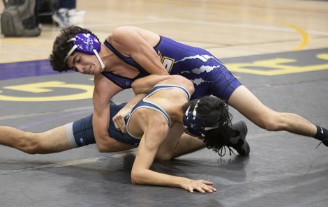 Freshman Ivan Aries pinned his Redwood opponent to lead his team to victory over visiting Redwood High School Thursday night.